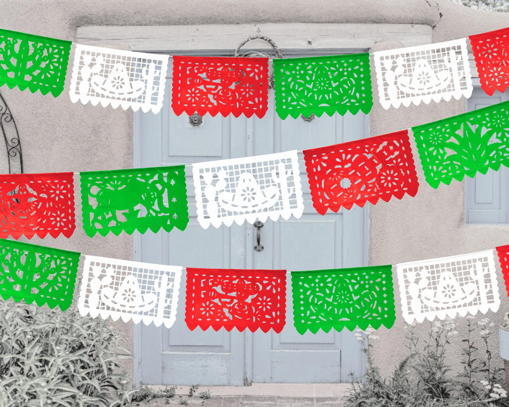 A colorful Papel Picado banner with red, white, and green triangles hanging across a door, featuring traditional Mexican patterns.