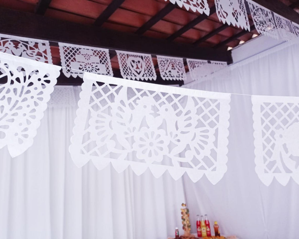 Decorative white paper cutouts hanging from a ceiling