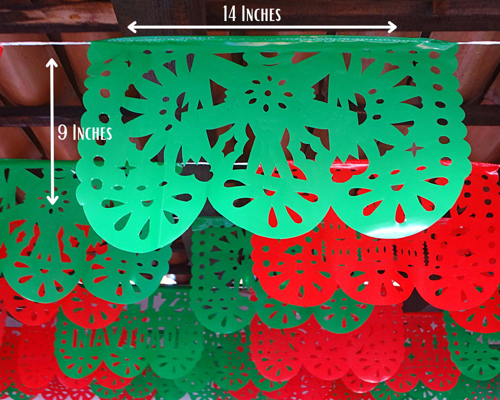 Green and red papel picado with measurements on a wooden surface