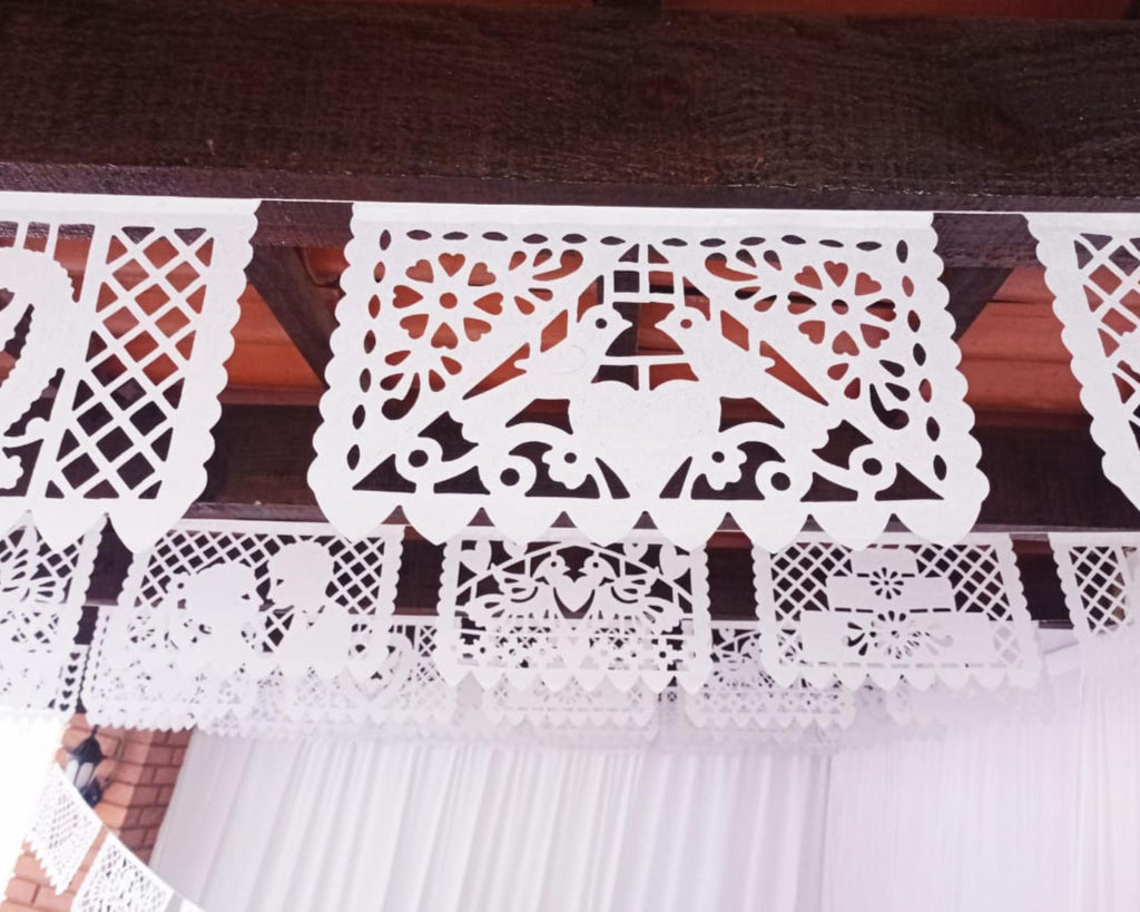 White lace paper flags from Mexico with intricate patterns
