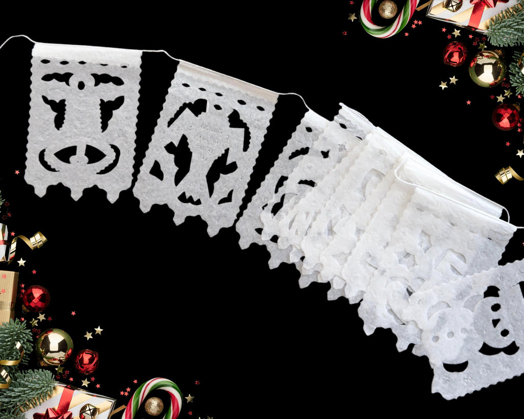 white papel picado banner with Christmas decorations in the background